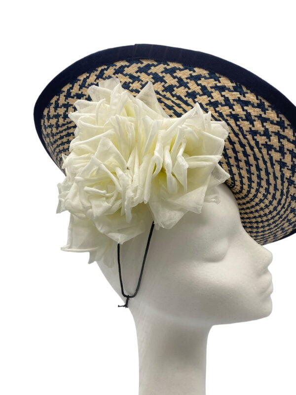 Stunning nacy and cream parassisal straw side saucer headpiece with navy trim detail and beautiful ivory flowers to finish.